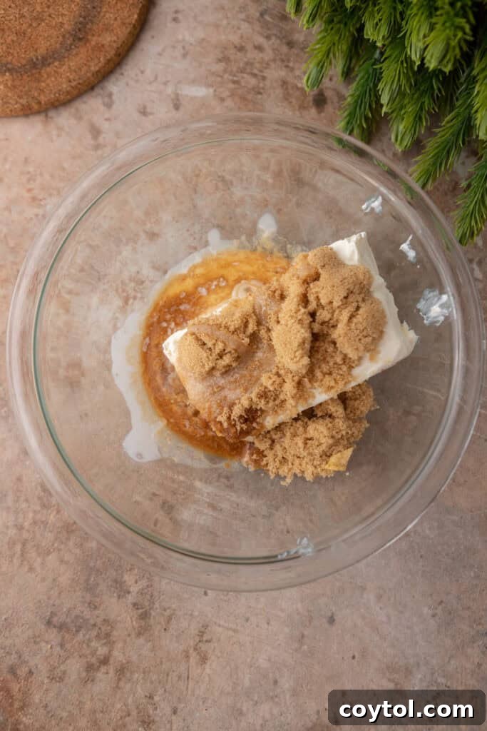 Unmixed ingredients for the cream cheese layer in a mixing bowl.