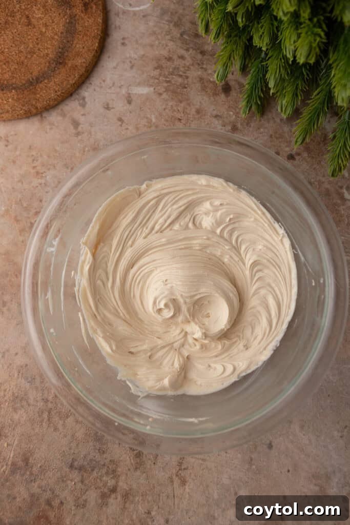 Mixed ingredients for the cream cheese layer after beating in a bowl.
