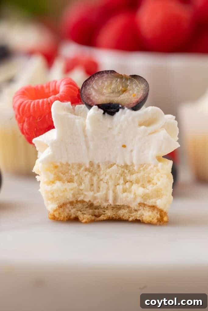 A mini cheesecake with Nilla Wafer crust, perfectly split open to reveal its creamy, luscious interior and the golden wafer base.