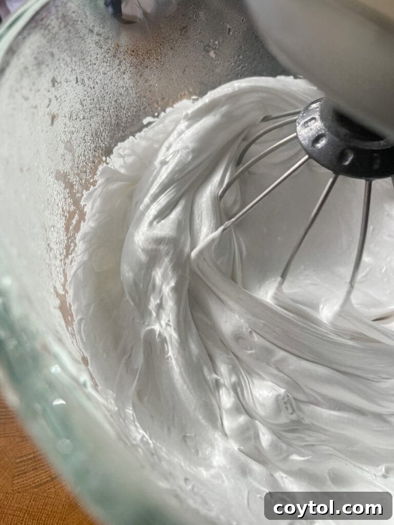 marshmallow mixture whipping to a fluffy consistency in a stand mixer