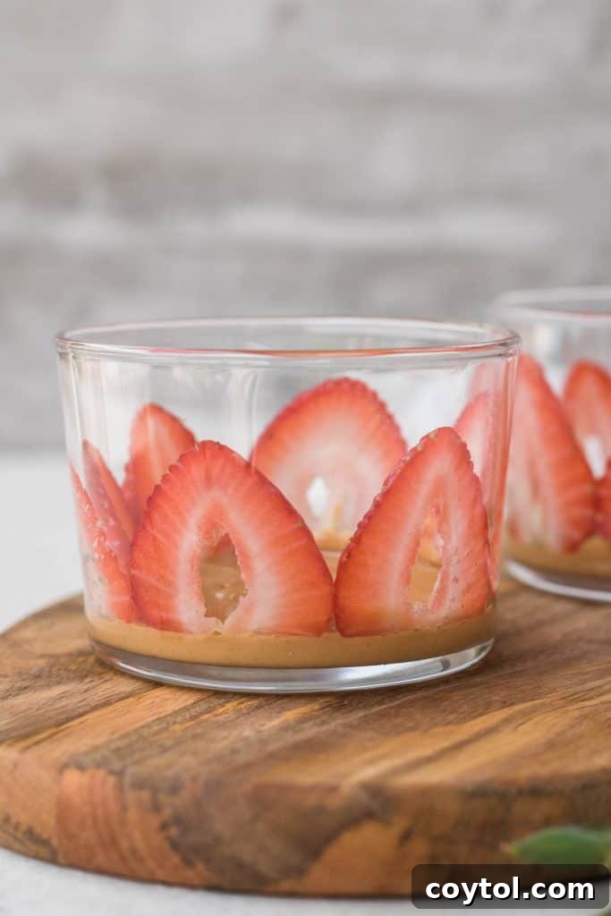 Strawberry Peanut Butter Chia Dream 16 Sliced strawberries pressed against the inside of a glass cup.