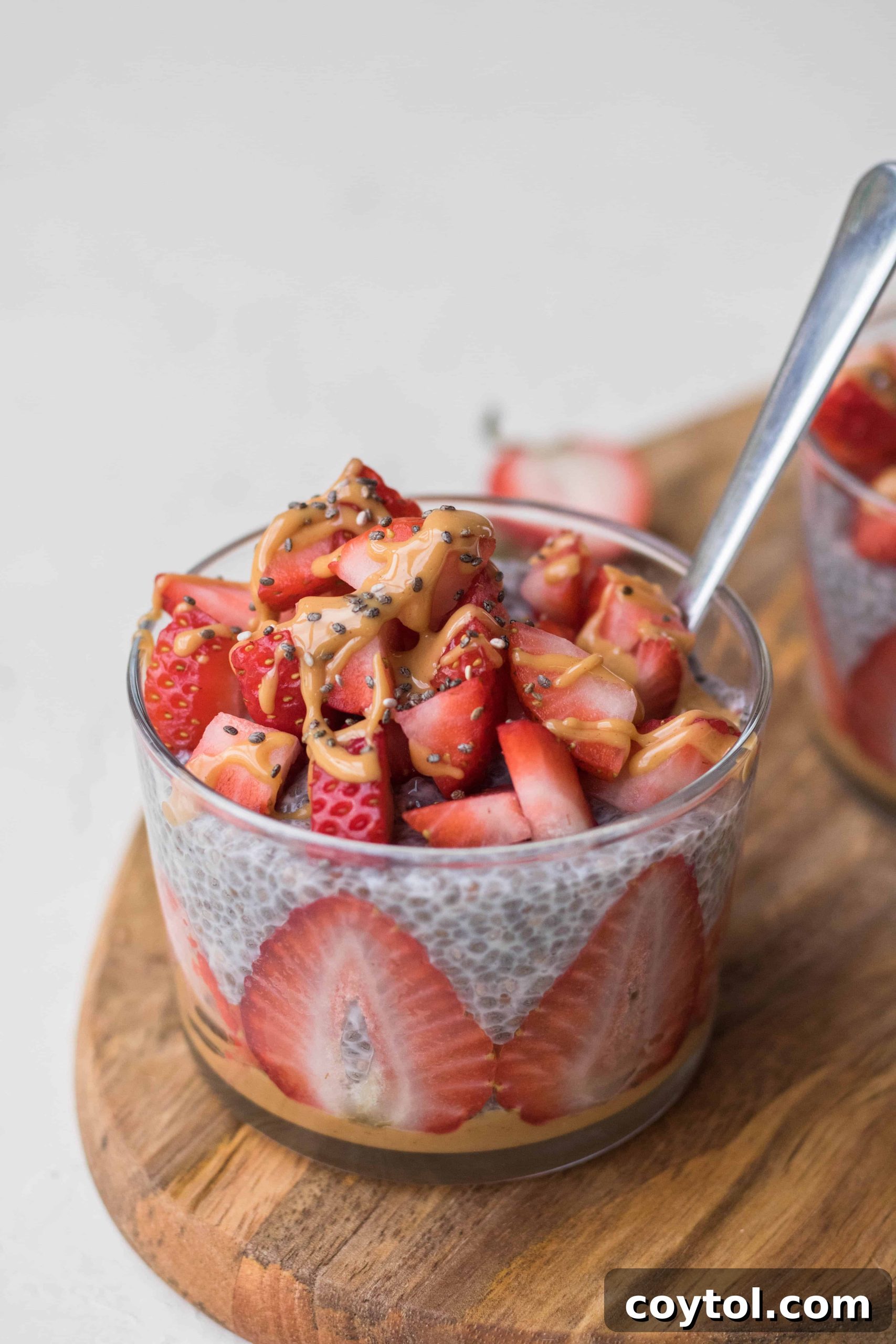 Strawberry Peanut Butter Chia Dream 4 Appetizing strawberry peanut butter chia seed pudding with fresh berries and nuts, ready to be eaten.