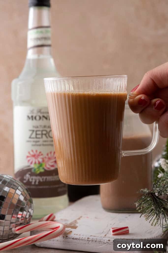 Homemade Peppermint Mocha Creamer: Your Cozy Coffee Upgrade 4 Hand holding coffee cup