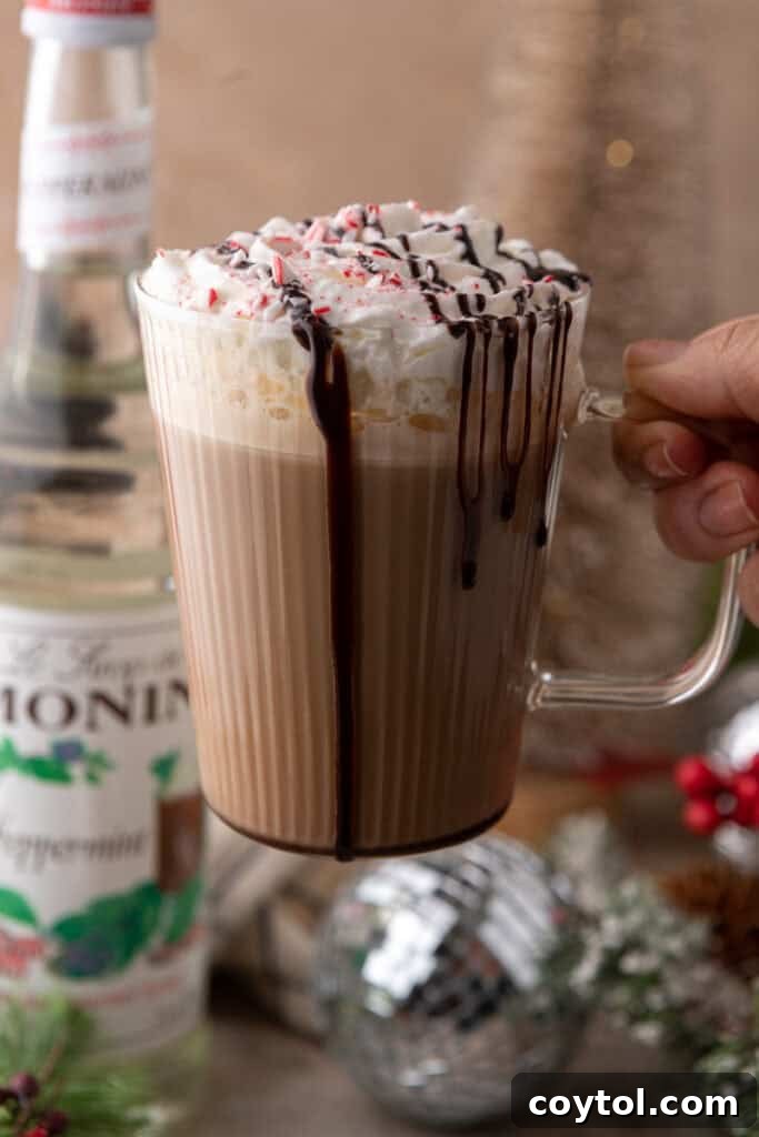 Mastering Starbucks Peppermint Mocha at Home 14 A hand holding a Starbucks Peppermint Mocha recipe with a blurred background