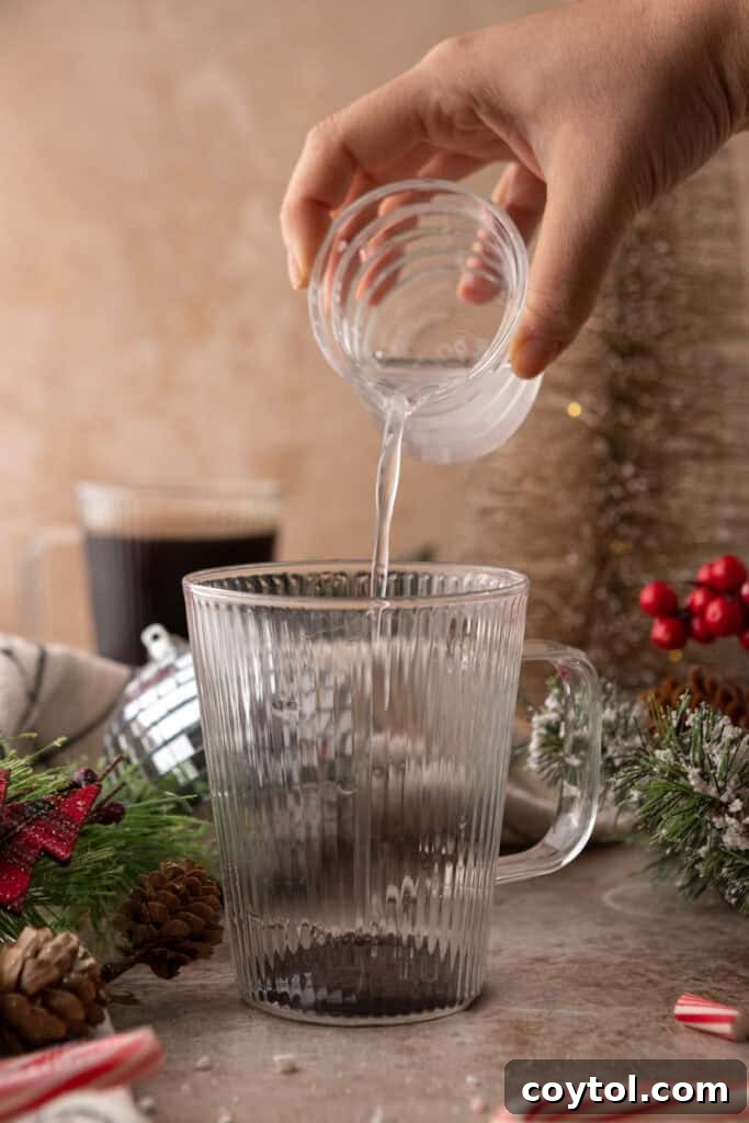 Mastering Starbucks Peppermint Mocha at Home 6 Peppermint syrup being poured into a cup for Peppermint Mocha recipe