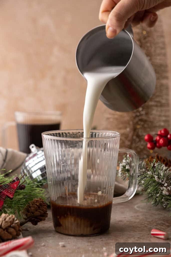 Mastering Starbucks Peppermint Mocha at Home 8 Steamed milk being poured into a cup for Peppermint Mocha recipe