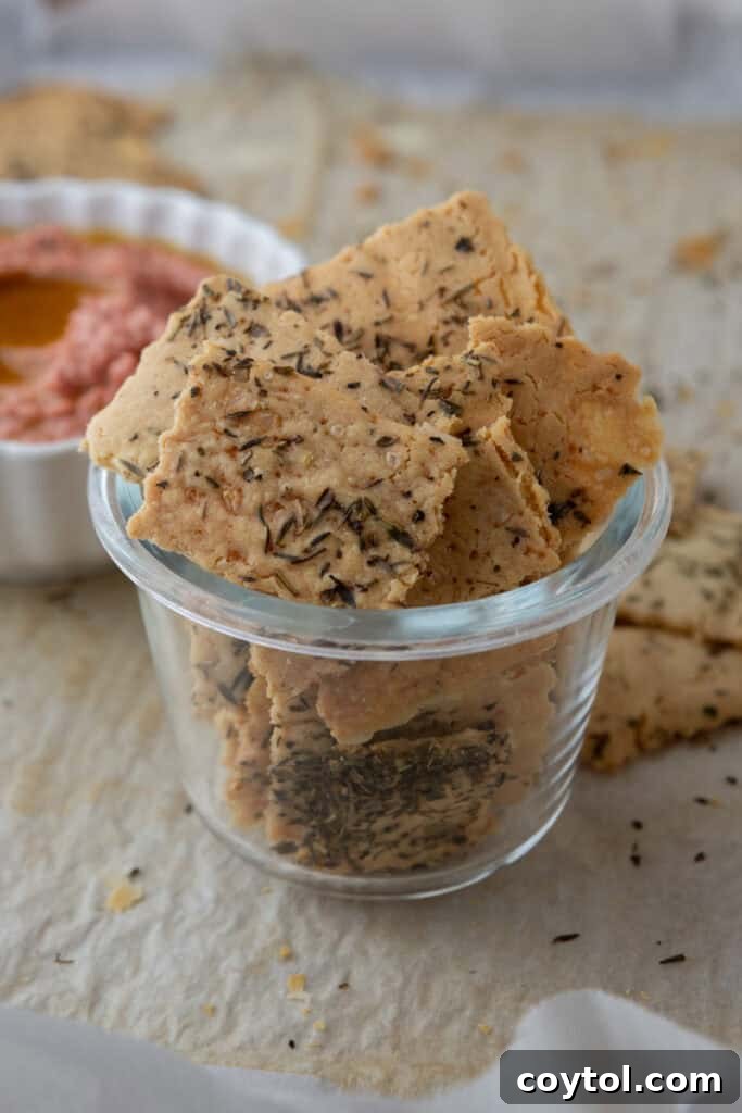 Crispy homemade sourdough discard crackers stored in a glass jar, perfect for snacking.