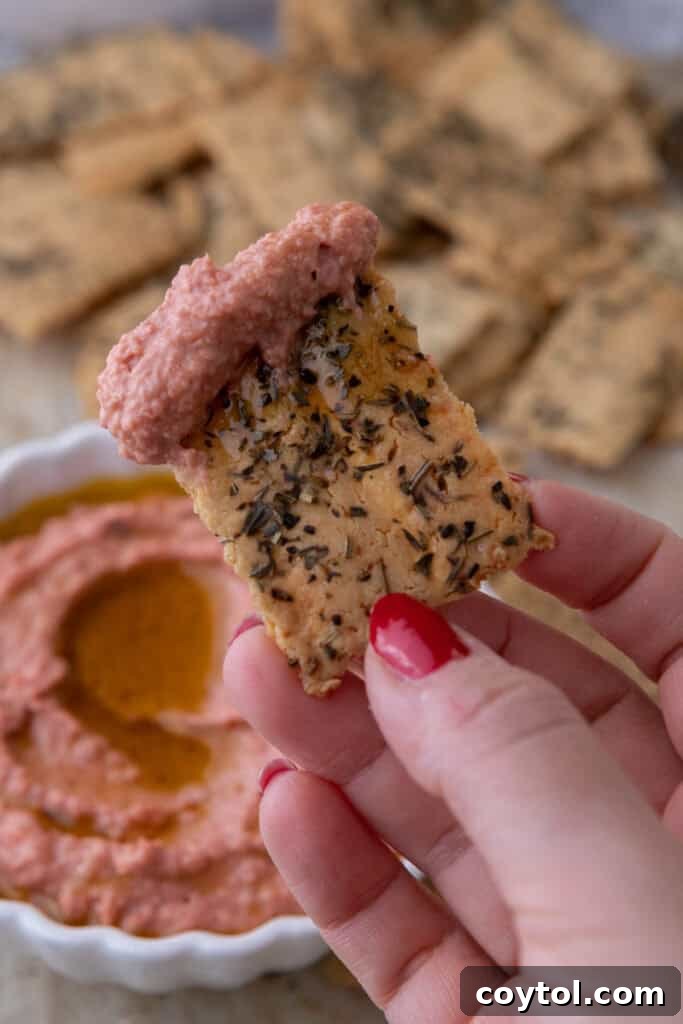 Close-up of crispy sourdough discard crackers served in a bowl, ready for dipping.