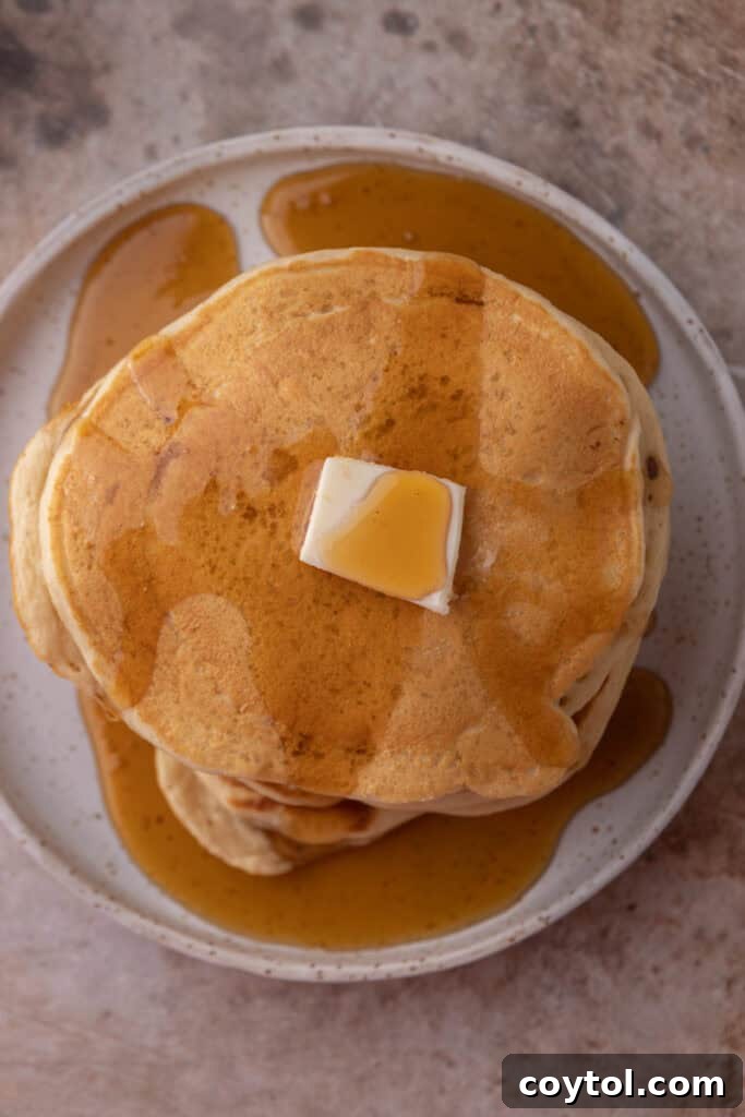 Overhead shot of a plate of Sourdough discard Pancakes, showcasing their fluffy texture and golden color.