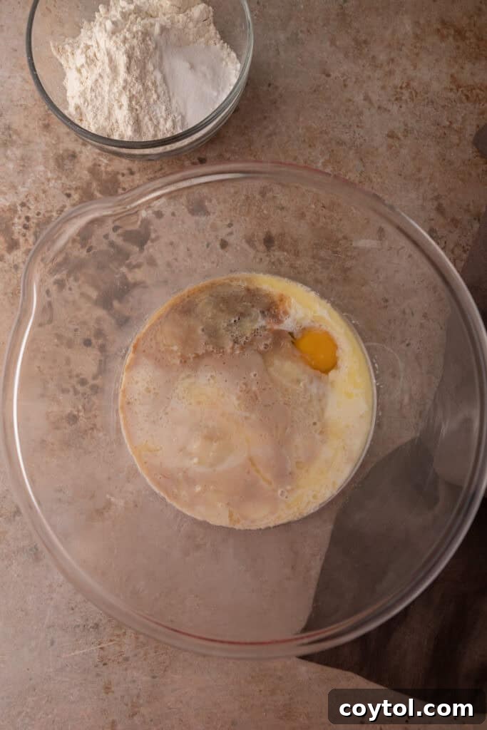 Close-up of unmixed wet ingredients in a bowl for sourdough discard pancakes.