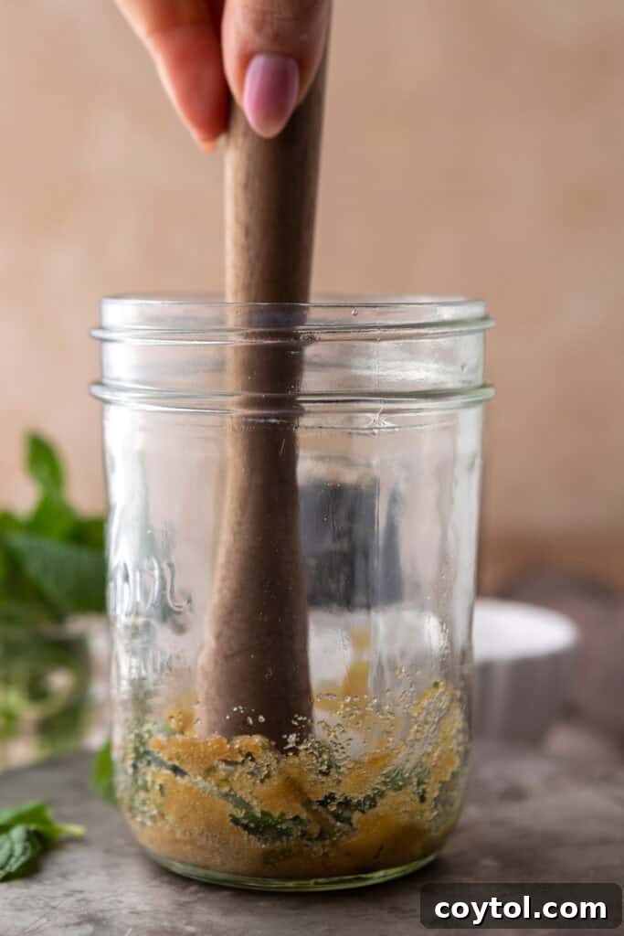 Hand muddling mint and brown sugar