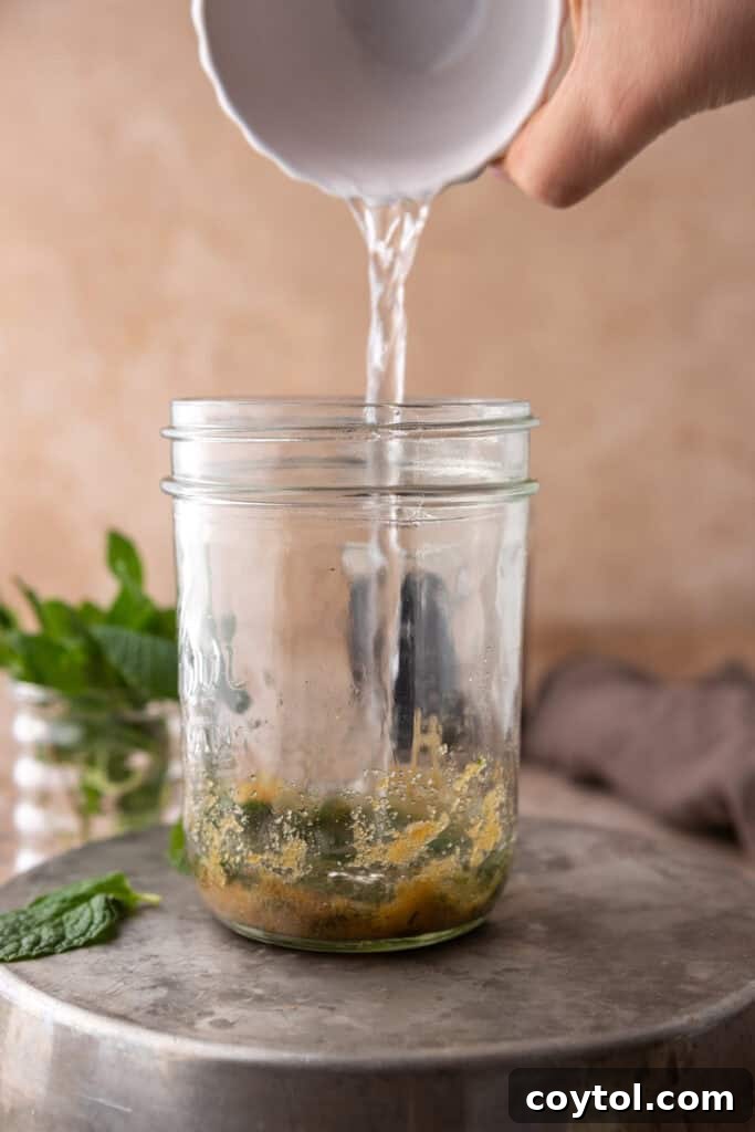 Hand pouring hot water in a cup