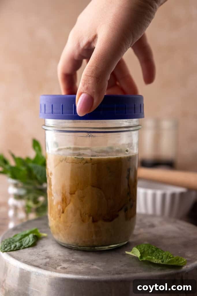 Hand closing lid of mason jar