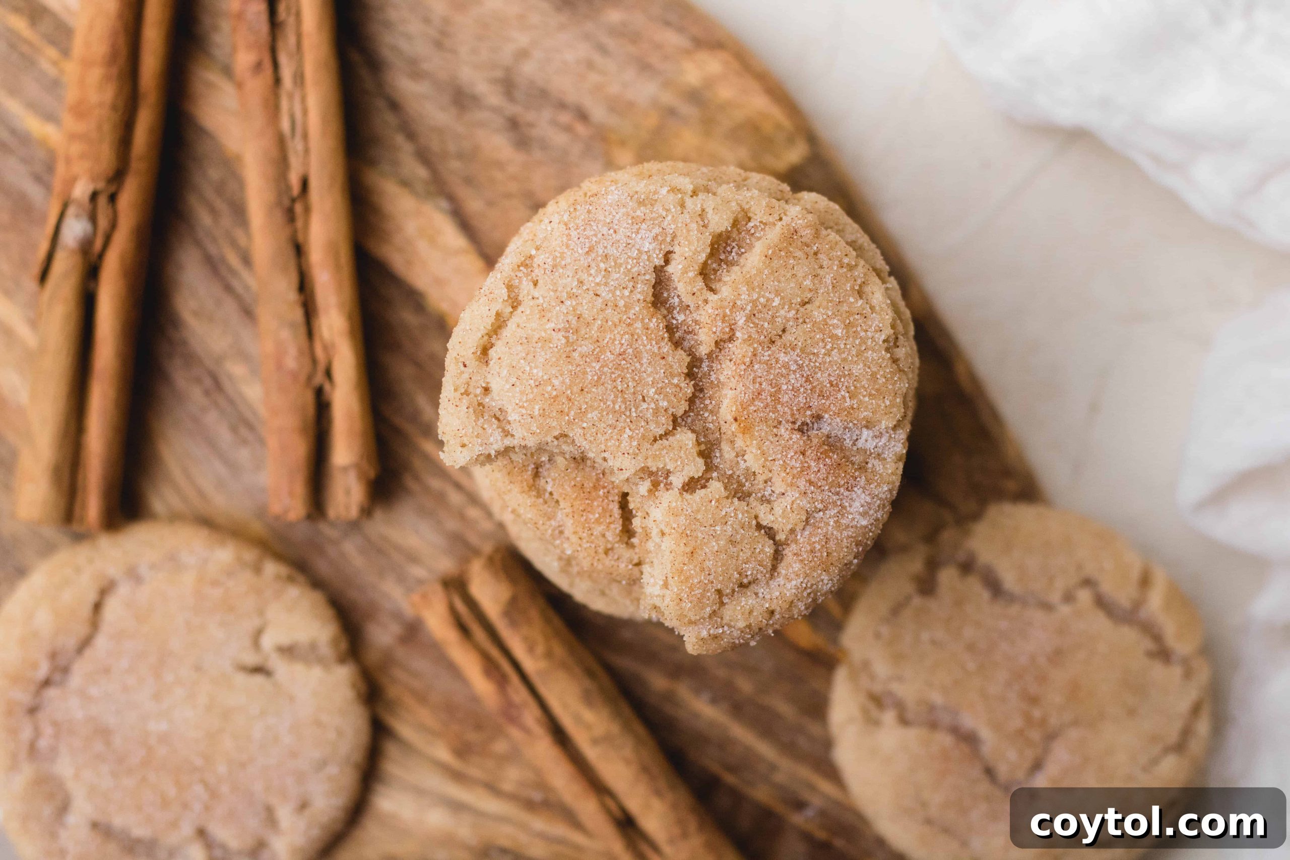 A stack of the best small batch snickerdoodles cookies on a wooden board