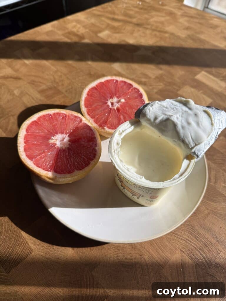 A refreshing grapefruit and vanilla bean yogurt served elegantly on a plate, showcasing a gourmet snack option.