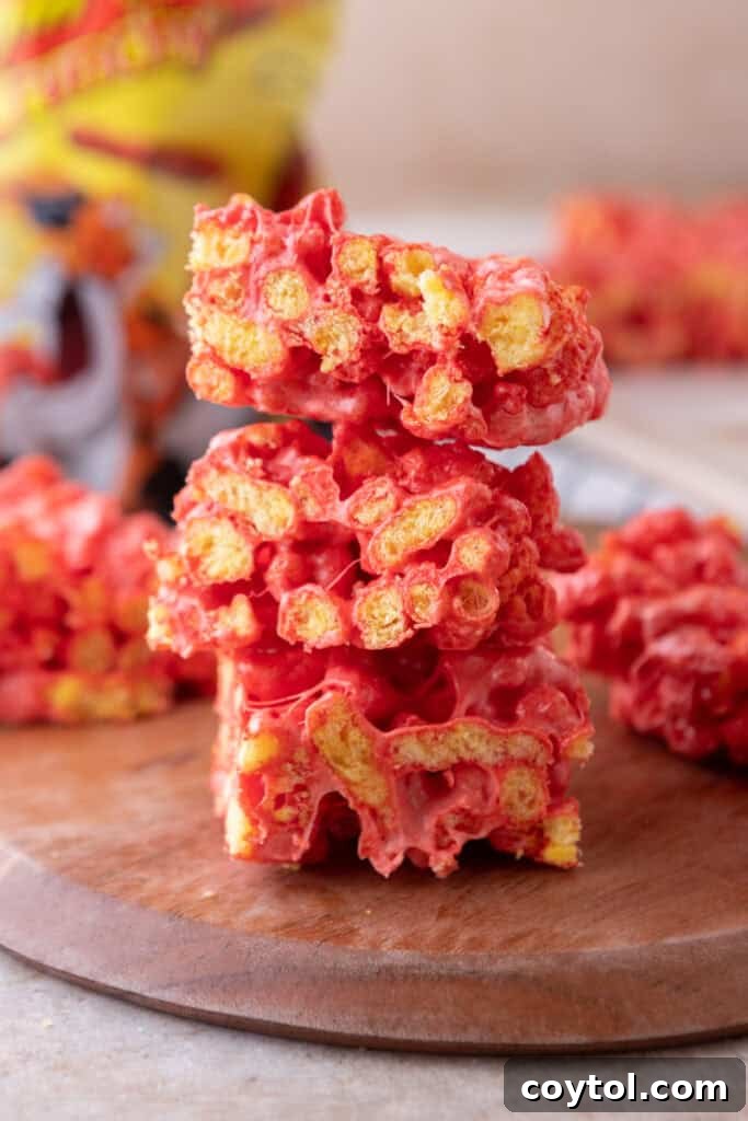 Stacked Hot Cheetos Marshmallow Crispy Treats, showcasing their vibrant red color and gooey texture