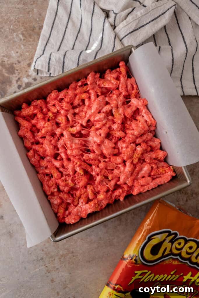 Hot Cheetos and marshmallow mixture pressed into a baking pan
