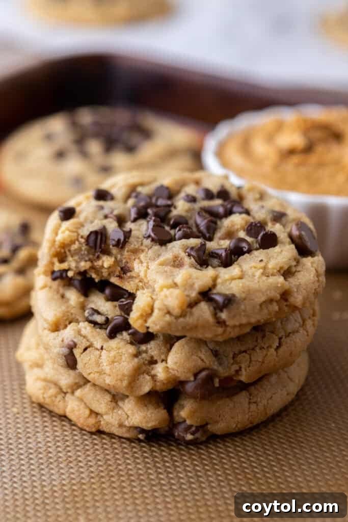 Stack of thick, chewy Peanut Butter Chocolate Chip Cookies with melty chocolate
