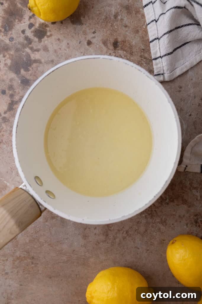 Zesty & Moist Lemon Bundt Perfection 11 Ingredients for lemon syrup in a saucepan on the stove