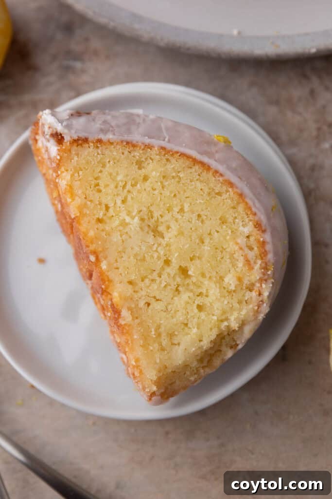 Zesty & Moist Lemon Bundt Perfection 18 Another appealing view of a single slice of lemon bundt cake, showing the moist interior and glossy glaze.