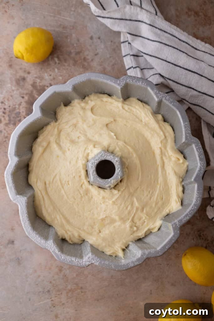 Zesty & Moist Lemon Bundt Perfection 10 Cake batter poured into a bundt pan, ready for baking