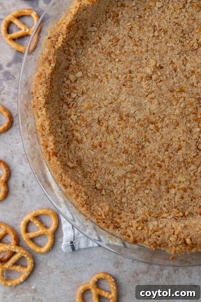 The Ultimate Salty Sweet Pretzel Pie Crust 2 Delicious Pretzel Pie Crust Recipe overhead shot in a pie dish, ready to be filled.