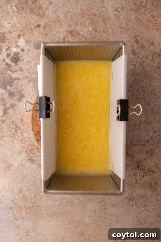 The lemon curd filling poured over the crust in the pan, before the second bake.