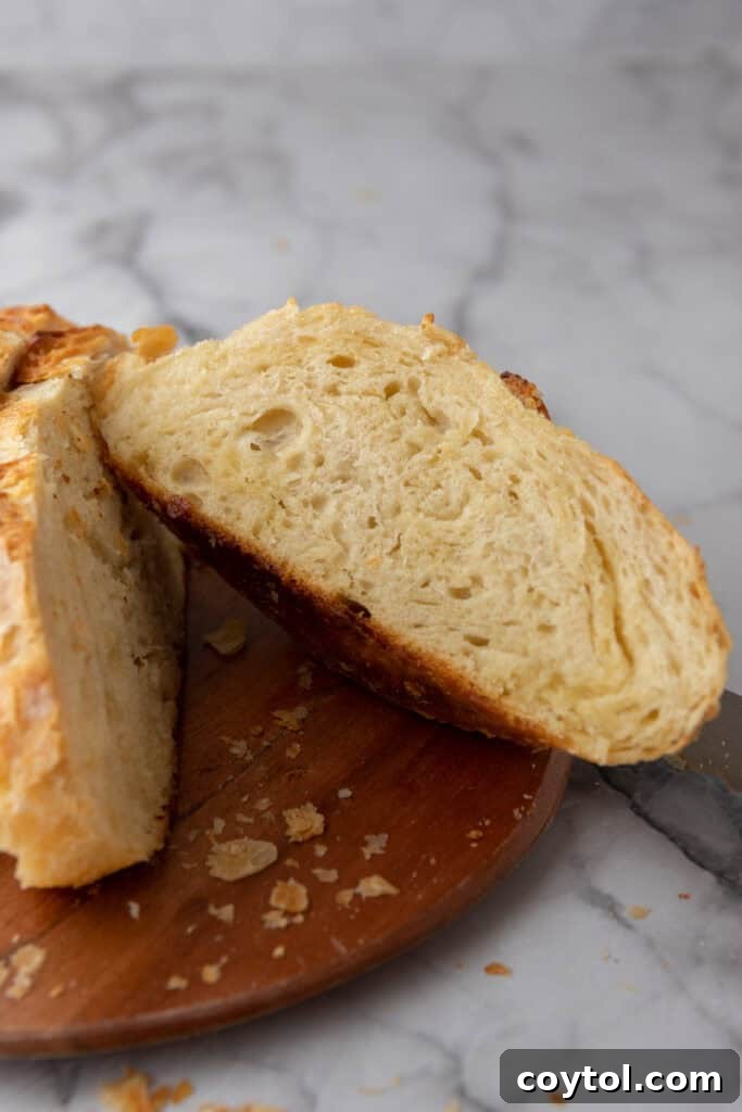 The intricate, laminated layers visible inside a freshly cut Sourdough Croissant Bread loaf, highlighting its croissant-like texture.