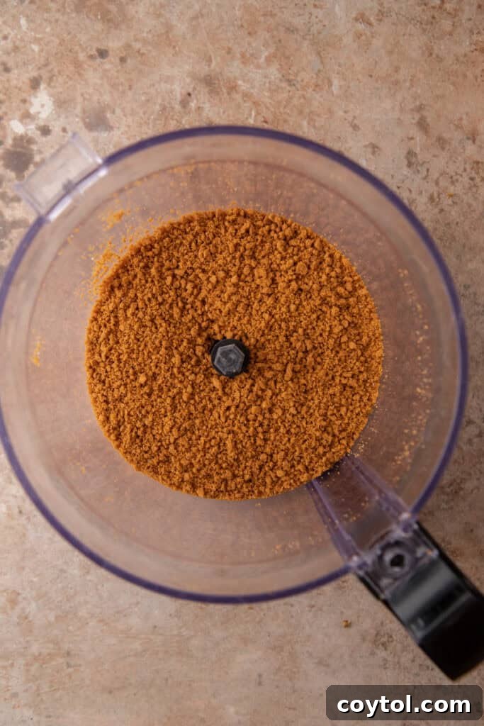Unlock the Secret to the Perfect Biscoff Pie Crust 5 Biscoff cookies being processed into fine crumbs in a food processor.