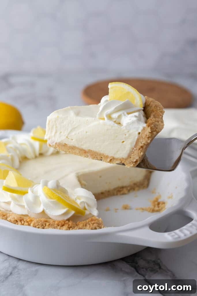 slice of the no bake lemon pie being held up 