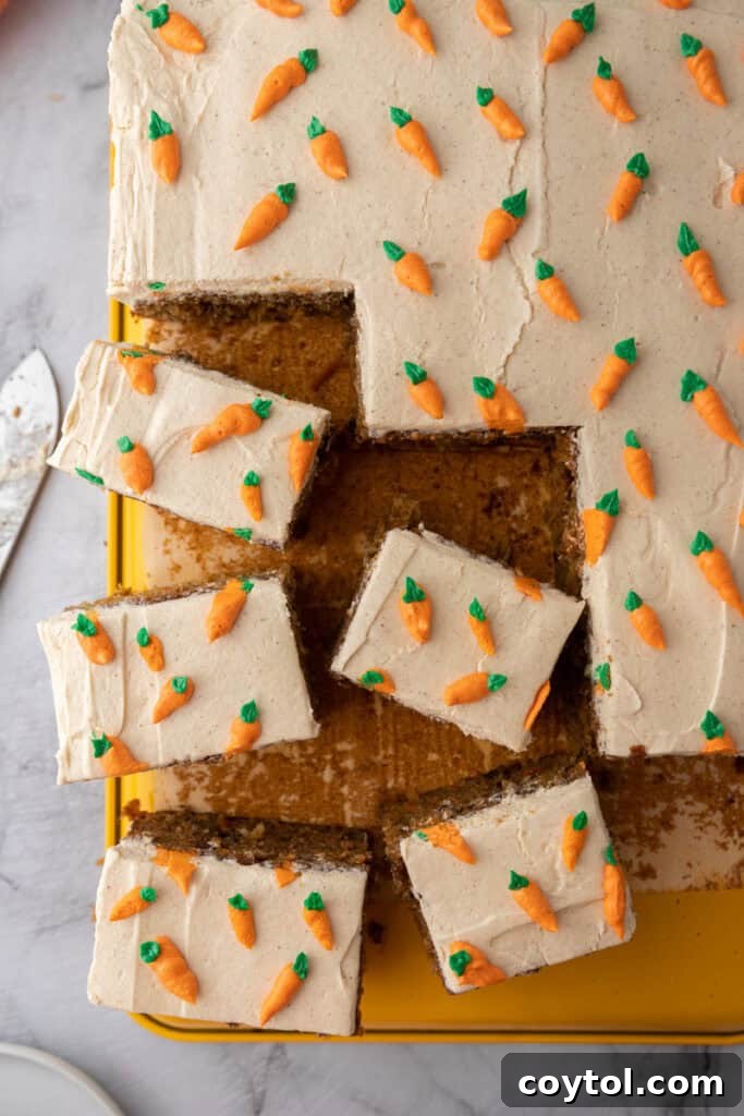 overhead shot of a beautifully frosted Carrot Cake Sheet Cake, garnished with small piped carrots, ready to be served for Easter or a spring celebration