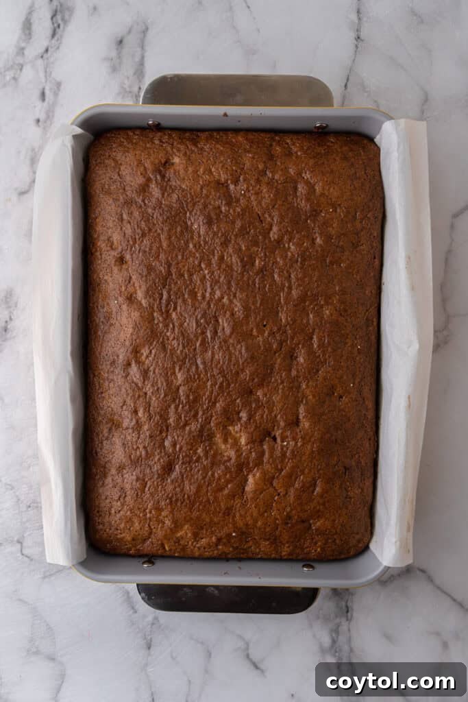 Freshly baked golden brown carrot cake in a sheet pan, just out of the oven