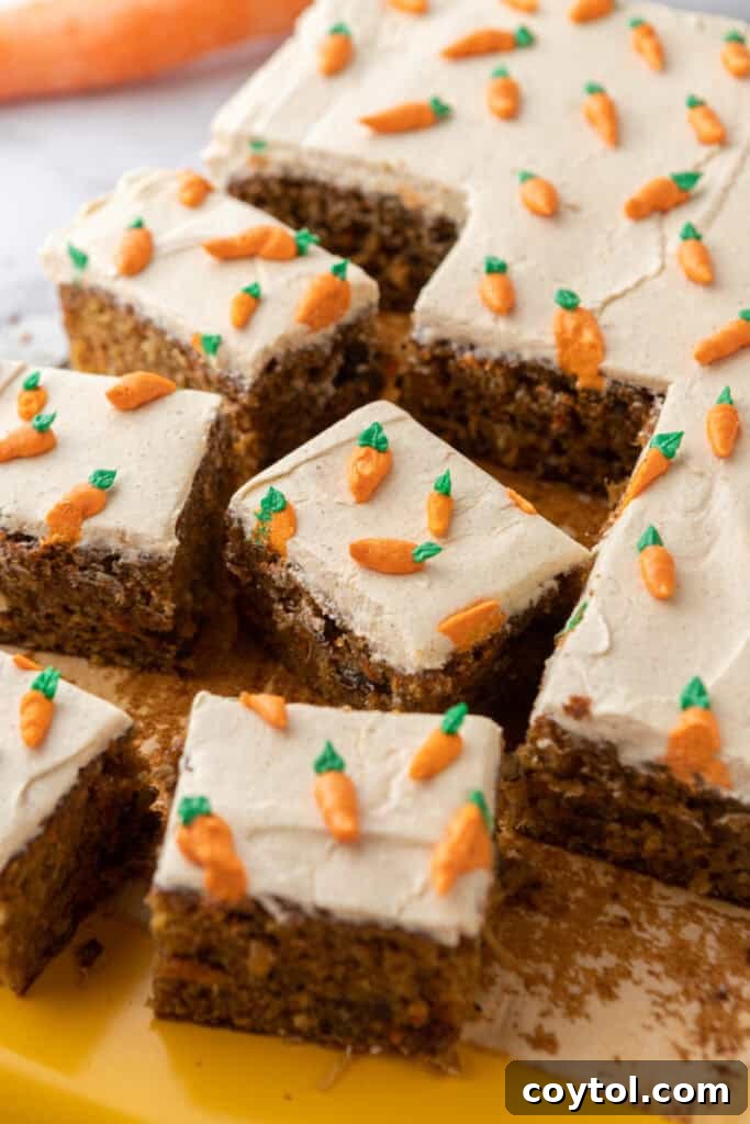Overhead view of the entire Carrot Cake Sheet Cake, frosted and decorated with piped carrots