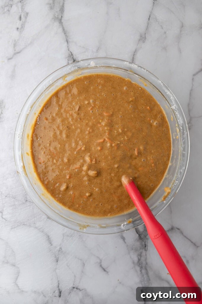 Fully mixed carrot cake batter in a bowl, ready for baking