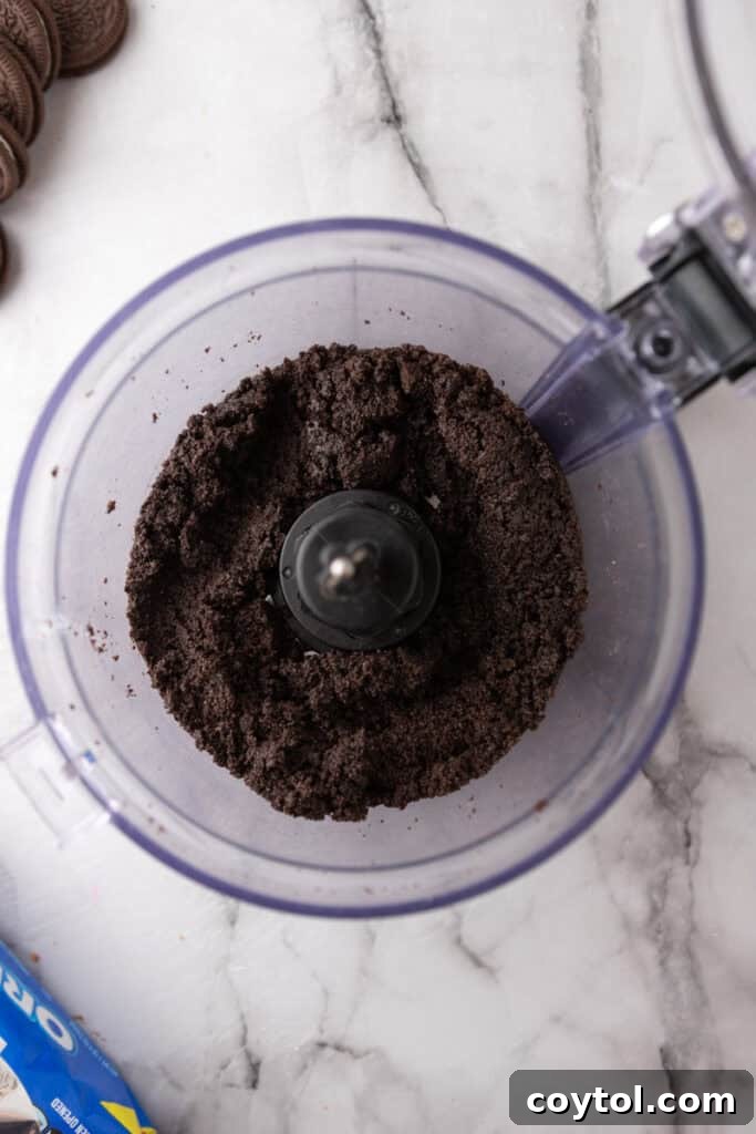 Mixed Oreo crumbs and butter in a food processor