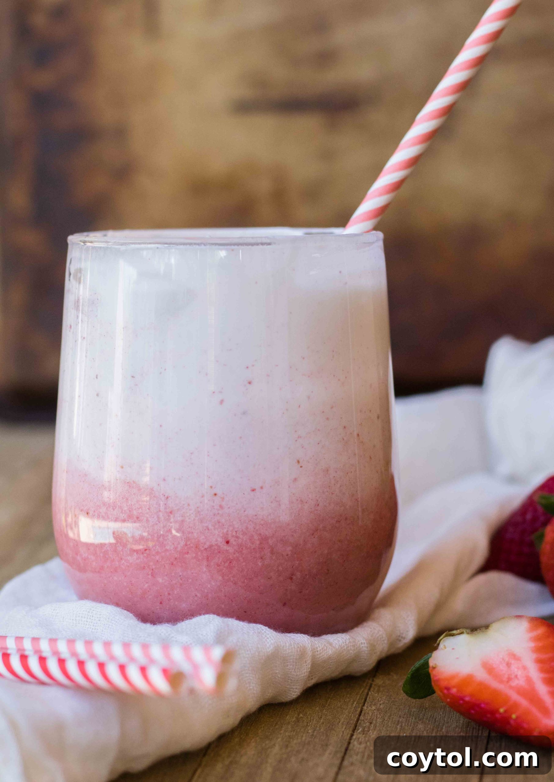 Banana strawberry healthy smoothie topped with ombre whipped cream