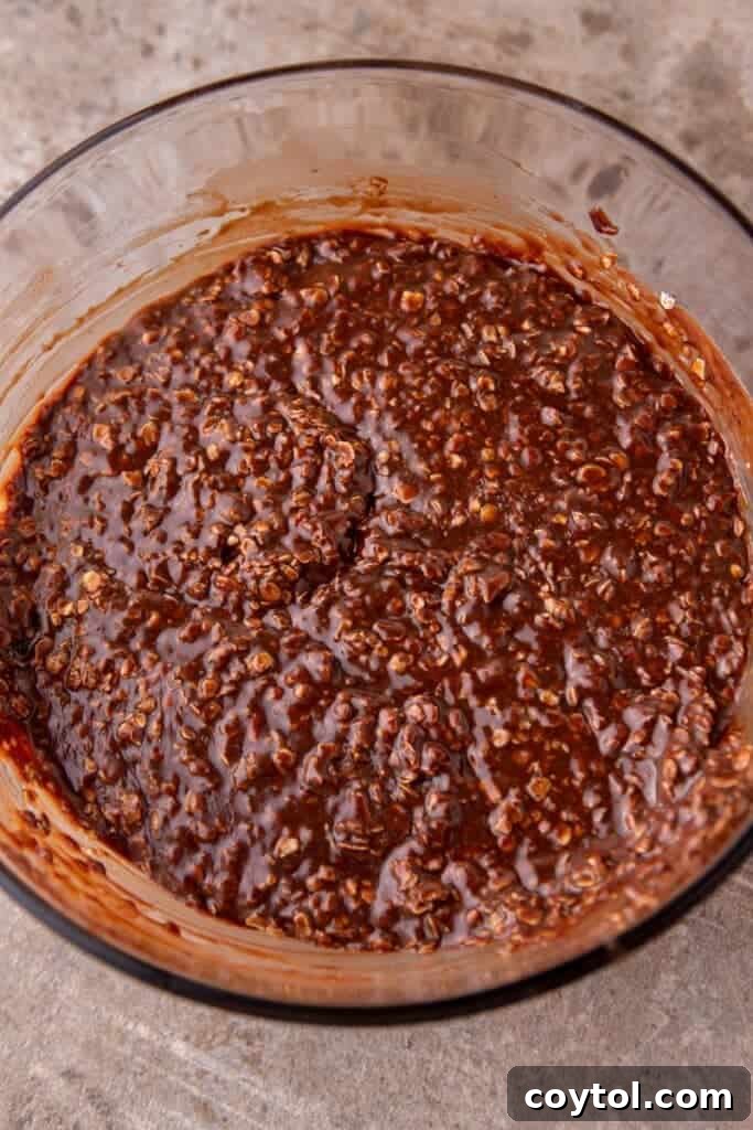 A bowl of the finished no-bake cookie mixture with oats, ready for scooping.