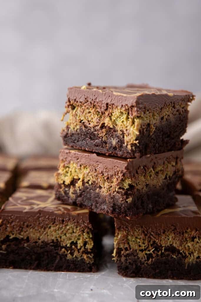 Close-up of Dubai Chocolate Brownies stacked, showcasing the layers and glossy chocolate top.