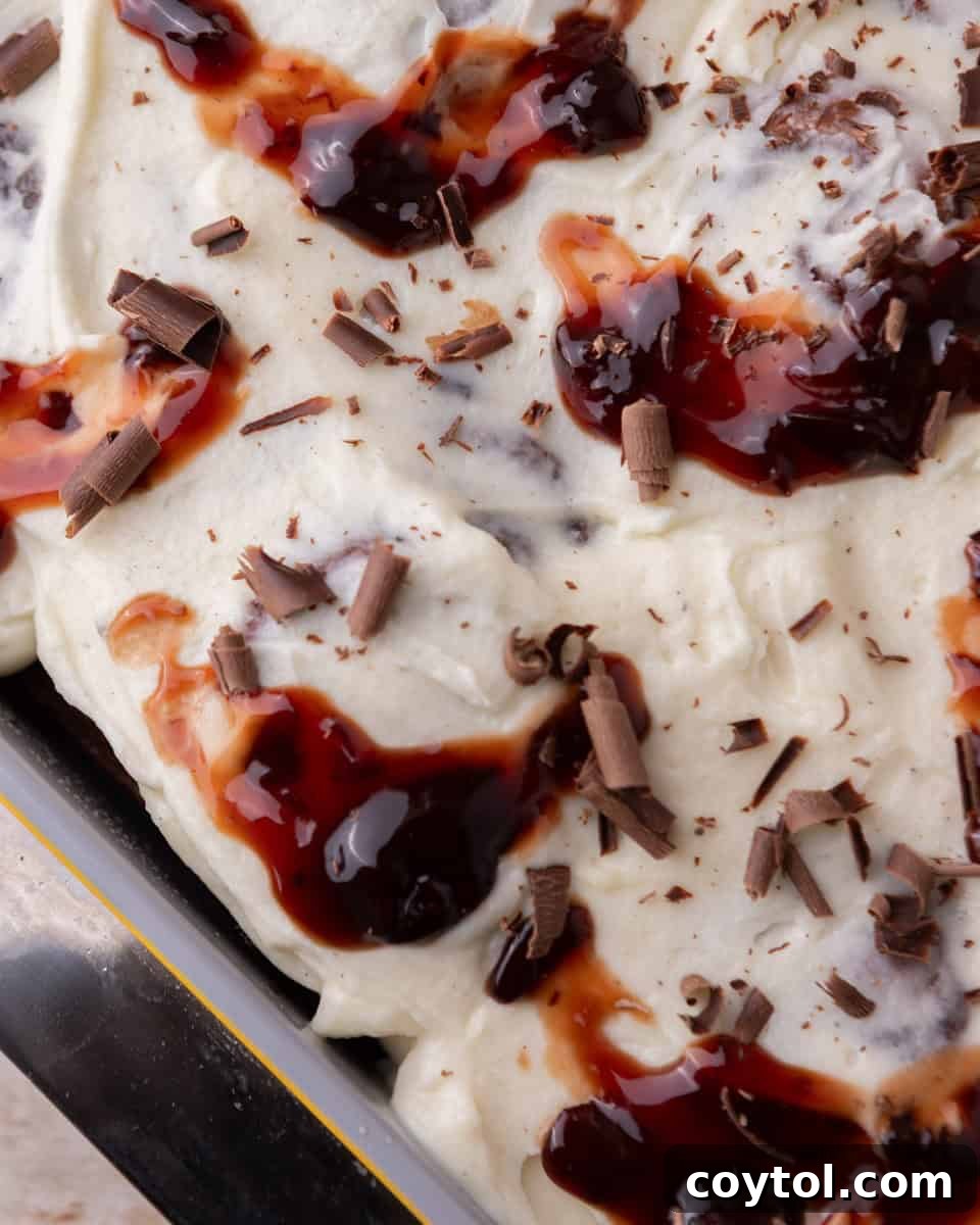 Close up of frosted rolls topped with cherries and chocolate shavings