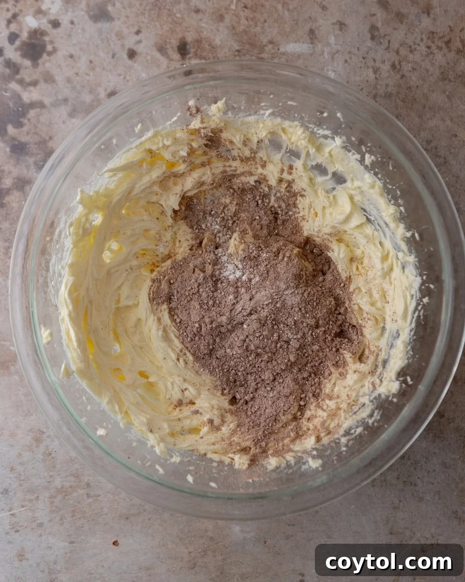 Chocolate cream cheese frosting being mixed in a bowl
