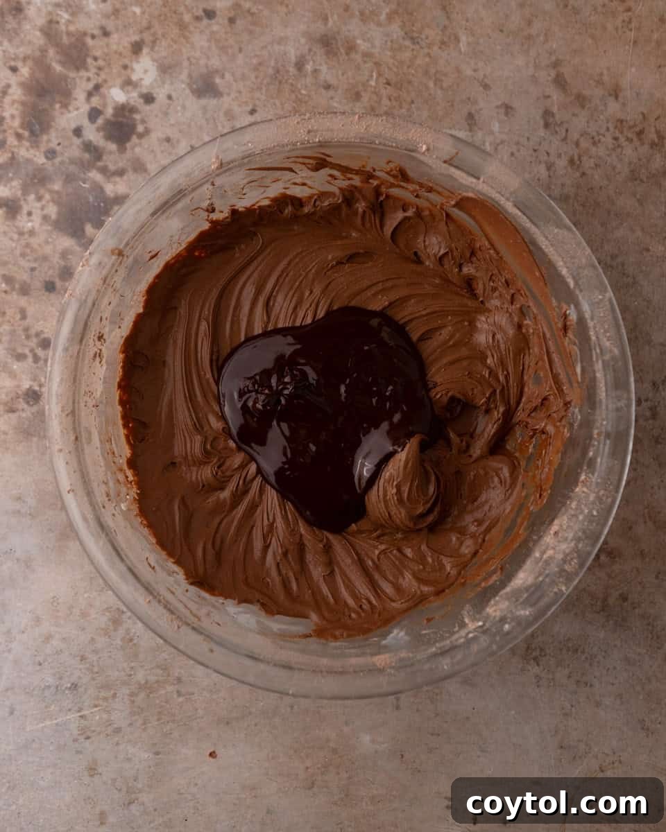 Melted chocolate added to chocolate cream cheese frosting