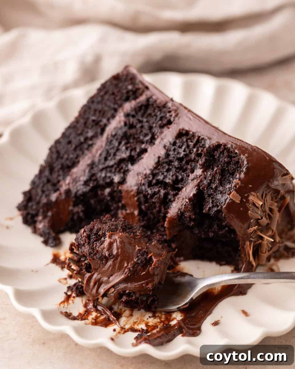 Fork cutting into a slice of fudgy chocolate beet cake