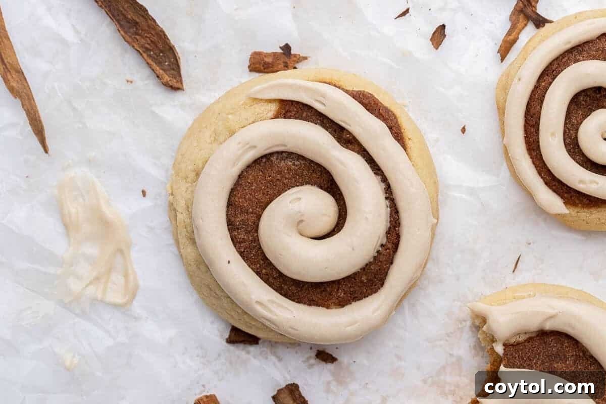 Crumbl maple cinnamon roll cookie with maple cream cheese frosting swirl