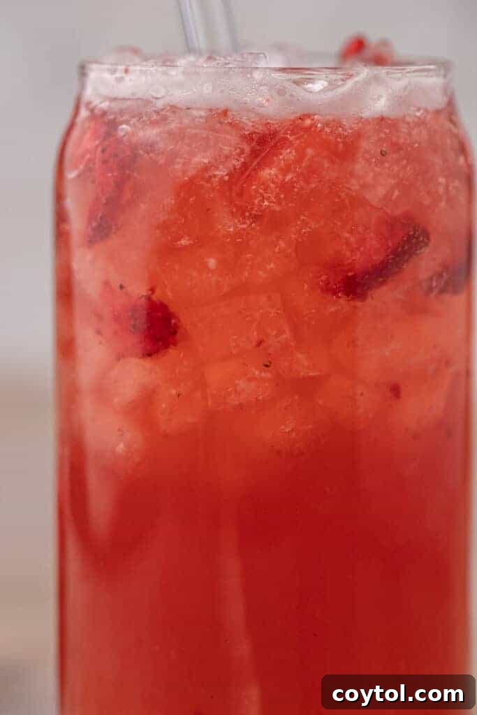 Unlock Starbucks Flavors: 65+ Beloved Recipes You Can Make 11 Starbucks copycat strawberry acai refresher with freeze dried strawberries and ice in a glass