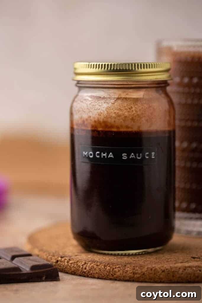 Unlock Starbucks Flavors: 65+ Beloved Recipes You Can Make 12 Homemade Starbucks mocha sauce stored in a glass jar with a gold lid for Starbucks copycat recipes
