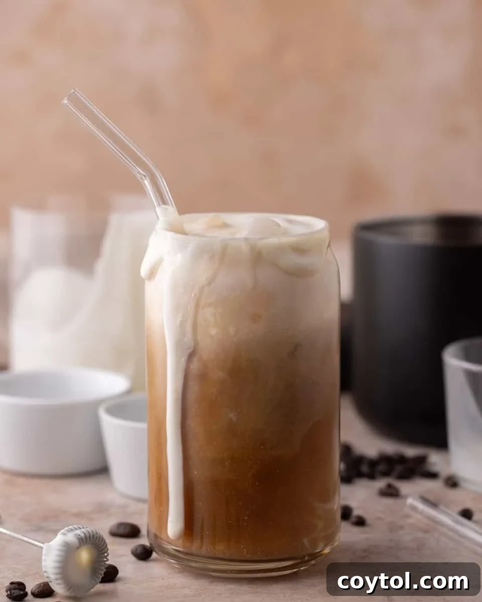 Unlock Starbucks Flavors: 65+ Beloved Recipes You Can Make 13 Thick vanilla sweet cream cold foam overflowing on top of a homemade Starbucks iced cold brew