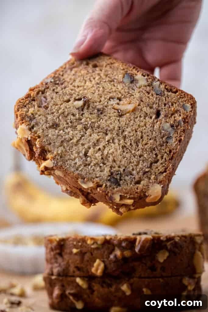 Unlock Starbucks Flavors: 65+ Beloved Recipes You Can Make 17 Moist Starbucks copycat banana bread slice with walnuts showing dense bakery-style crumb