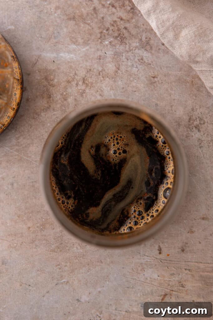 Unlock Starbucks Flavors: 65+ Beloved Recipes You Can Make 8 Overhead shot of freshly brewed espresso with crema swirl used in Starbucks copycat recipes