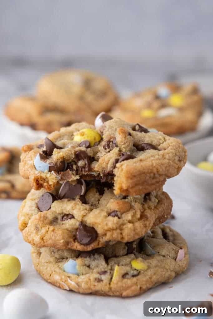 Effortless Easter Treats: Over 20 Recipes for a Memorable Spring Feast 3 Brown butter Cadbury mini egg cookies stacked on parchment paper one of the best easy easter dessert recipes