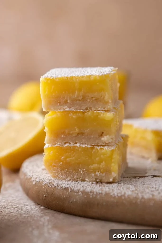 Effortless Easter Treats: Over 20 Recipes for a Memorable Spring Feast 6 Classic lemon bars dusted with powdered sugar a popular easter dessert on a wooden board with fresh lemons